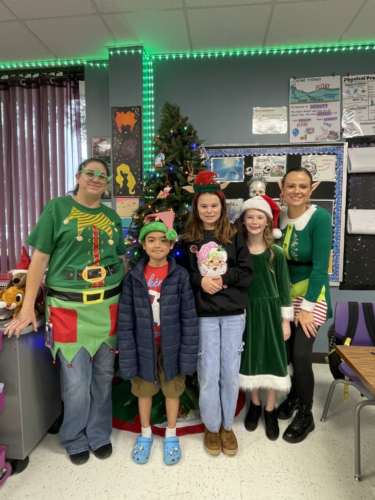 "Selfie with an Elfie! Our halls are officially under elf surveillance today! From sparkly sequins to striped socks, our students and staff definitely understood the assignment. We love seeing so much creativity and joy walking through the school!  Reminder: Don't forget that tomorrow is Rudolph/Reindeer Day!