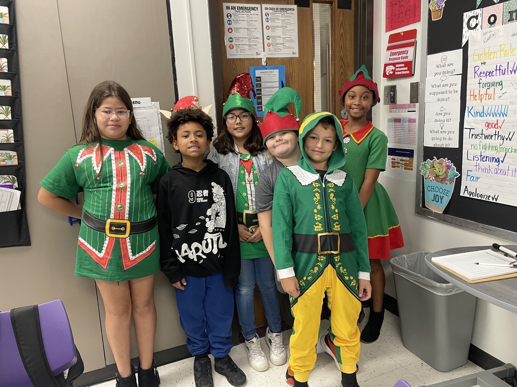 "Selfie with an Elfie! Our halls are officially under elf surveillance today! From sparkly sequins to striped socks, our students and staff definitely understood the assignment. We love seeing so much creativity and joy walking through the school!  Reminder: Don't forget that tomorrow is Rudolph/Reindeer Day!