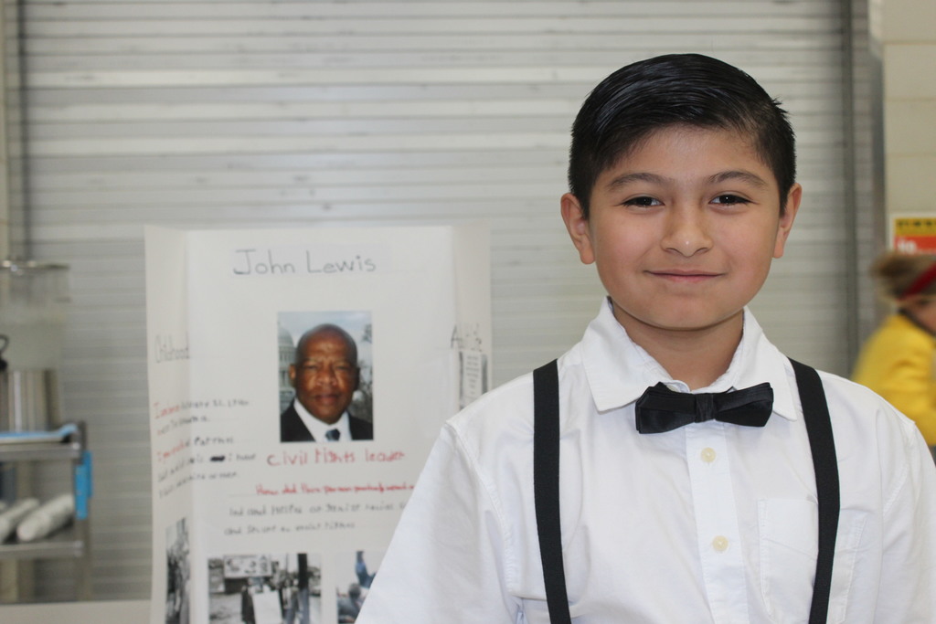 Our 5th graders transformed our cafeteria into a Living Wax Museum today in honor of Black History Month.  Visitors had to find the "magic button" at each station to bring these historical icons to life. Once "activated," students stepped out of their wax-like poses to share powerful stories—in character!—about leaders like John Lewis, Ruby Bridges, and Malcolm X.  Seeing our students take such pride in their research and public speaking was the highlight of our week! 🌟