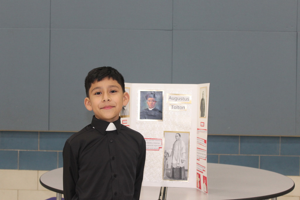 Our 5th graders transformed our cafeteria into a Living Wax Museum today in honor of Black History Month.  Visitors had to find the "magic button" at each station to bring these historical icons to life. Once "activated," students stepped out of their wax-like poses to share powerful stories—in character!—about leaders like John Lewis, Ruby Bridges, and Malcolm X.  Seeing our students take such pride in their research and public speaking was the highlight of our week! 🌟