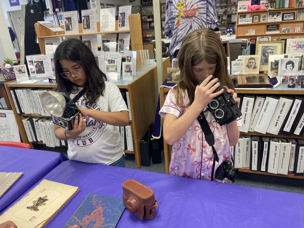 From vintage lenses to future layouts! Our Shutterbugs took a deep dive into the history of our community and craft during their recent trip to the History Center.  A massive thank you to Mrs. Winder for being such an incredible host! She opened up the archives, allowing our students to get hands-on with old camera equipment and explore the fascinating history of Angleton ISD.  We also got a "sneak peek" at the big leagues by visiting the High School yearbook staff and Mrs. Evans! Seeing where their photography journey can lead was so inspiring. Of course, no Shutterbugs trip is complete without a little fieldwork—the students took a creative break outside to practice their angles and capture the beauty of the day.