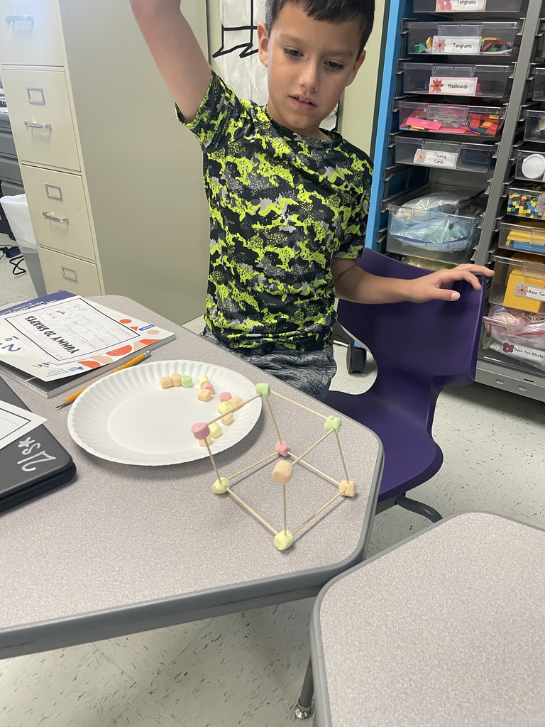 Engineering or snacking? In Mrs. Aaron’s 2nd-grade math class, it’s a bit of both! Our students are moving beyond the textbook to build 2D and 3D shapes from the ground up. By using marshmallows and toothpicks to represent vertices and edges, these young mathematicians are gaining a deeper understanding of geometric properties. Way to go, Grade 2!