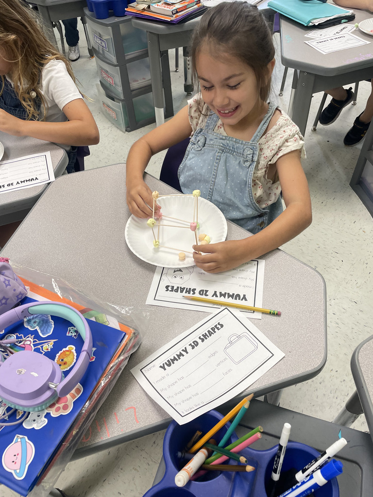 Engineering or snacking? In Mrs. Aaron’s 2nd-grade math class, it’s a bit of both! Our students are moving beyond the textbook to build 2D and 3D shapes from the ground up. By using marshmallows and toothpicks to represent vertices and edges, these young mathematicians are gaining a deeper understanding of geometric properties. Way to go, Grade 2!