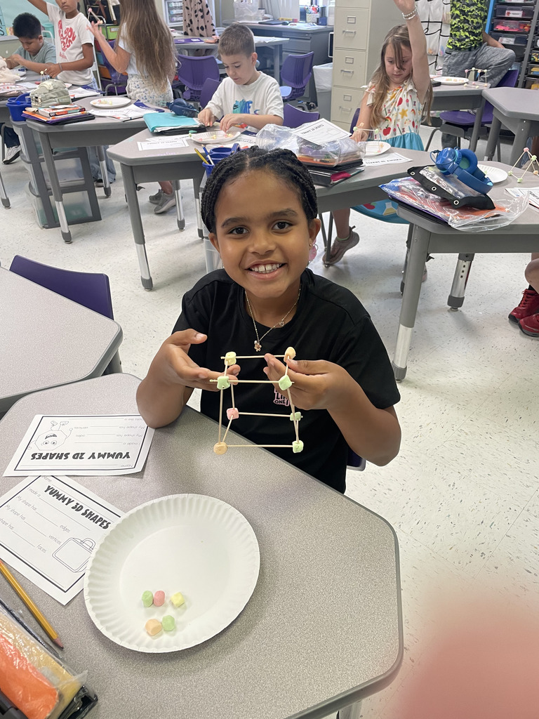 Engineering or snacking? In Mrs. Aaron’s 2nd-grade math class, it’s a bit of both! Our students are moving beyond the textbook to build 2D and 3D shapes from the ground up. By using marshmallows and toothpicks to represent vertices and edges, these young mathematicians are gaining a deeper understanding of geometric properties. Way to go, Grade 2!