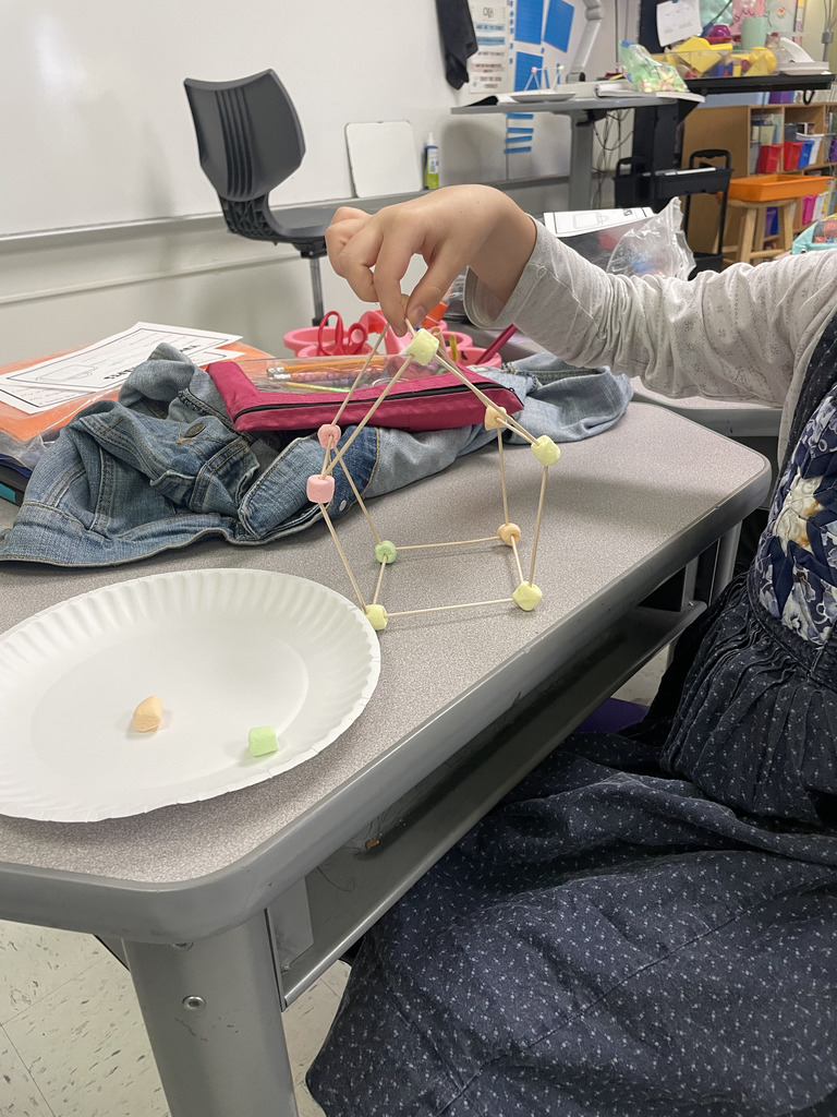 Engineering or snacking? In Mrs. Aaron’s 2nd-grade math class, it’s a bit of both! Our students are moving beyond the textbook to build 2D and 3D shapes from the ground up. By using marshmallows and toothpicks to represent vertices and edges, these young mathematicians are gaining a deeper understanding of geometric properties. Way to go, Grade 2!