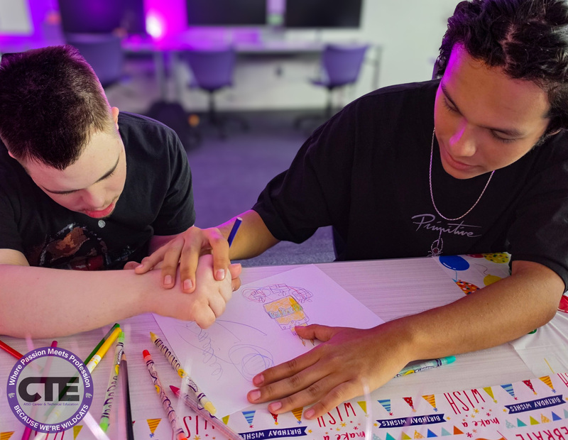 Student assisting guest artist with drawing