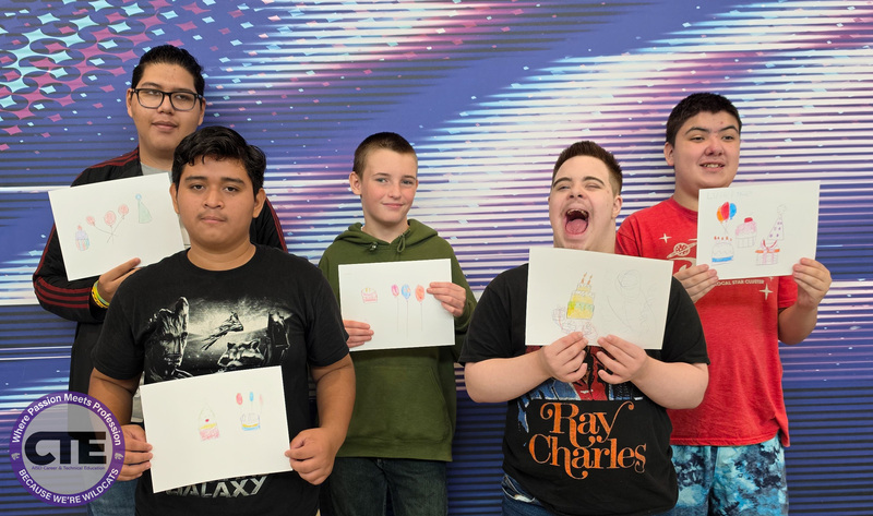 Guest student artists holding their artwork