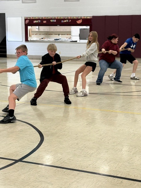 students playing tug of war at field day