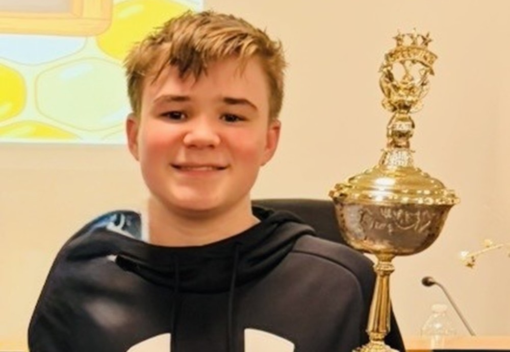 Quint Karlsson Spelling Bee Champion with trophy
