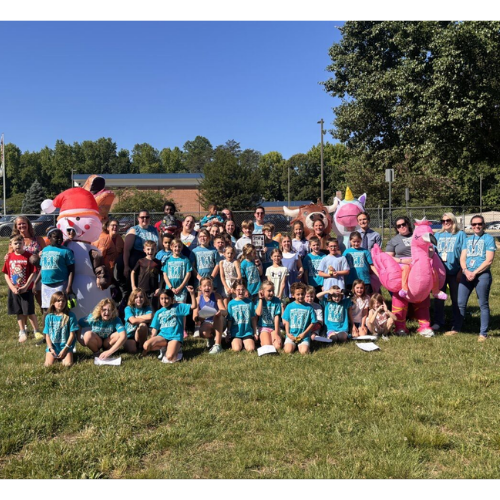 Central Elementary School's Best Buddies program participants in group photo with supporting staff members dressed in inflatable animal costumes