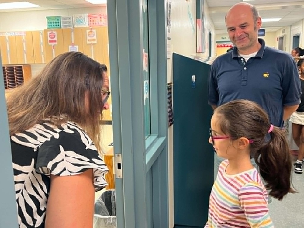 Teacher greeting student