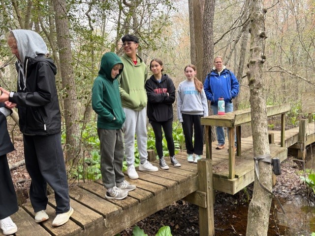 students observing the marsh boardwalk