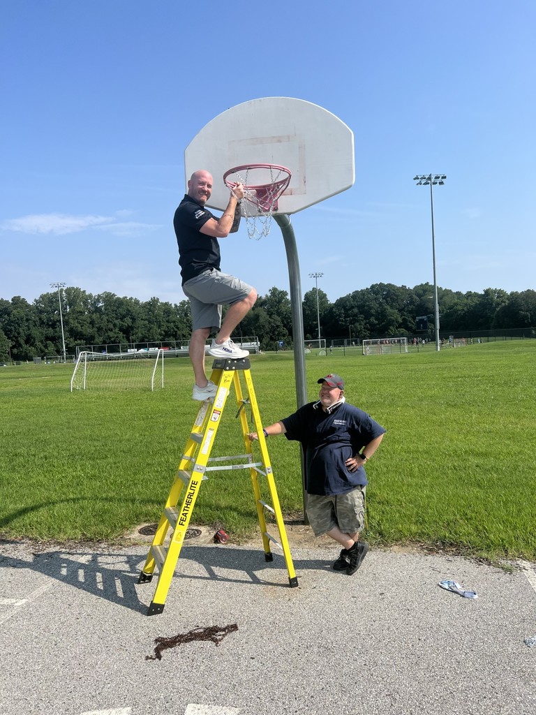 Principal putting up basketball hoop