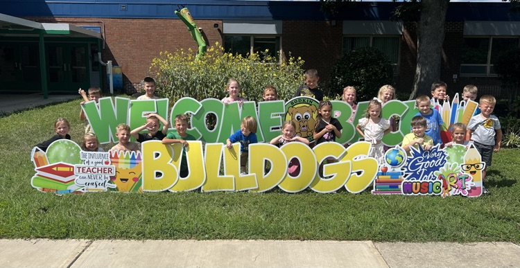 kids in front of welcome sign