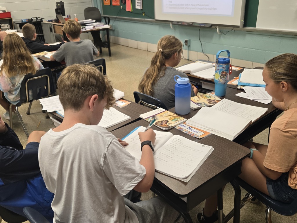 Students writing at desks