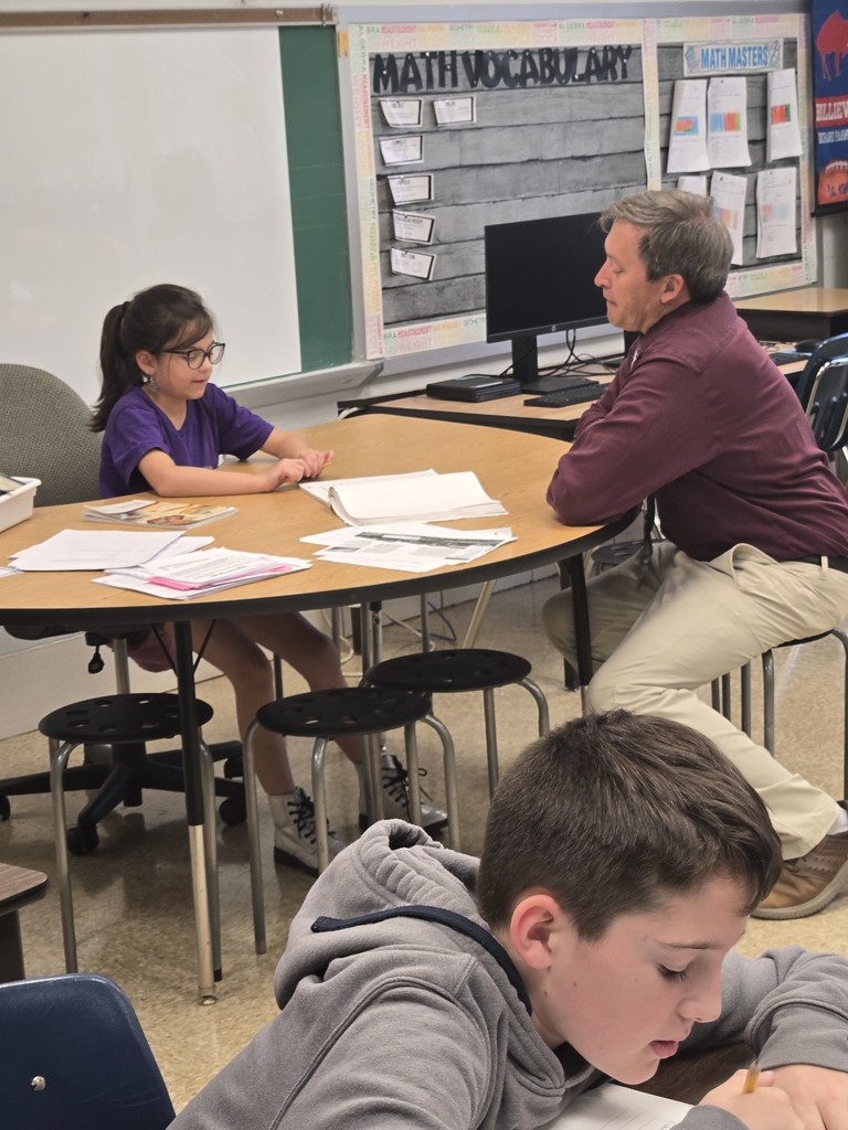 Male teacher at table with student 