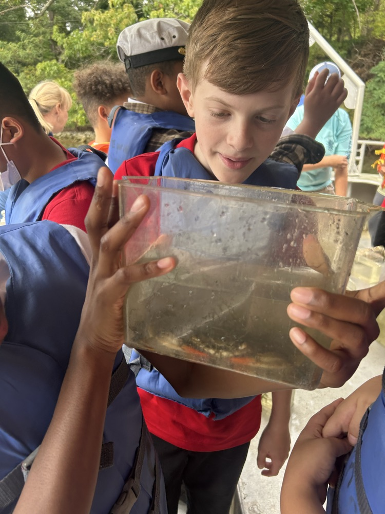 student holding crab 