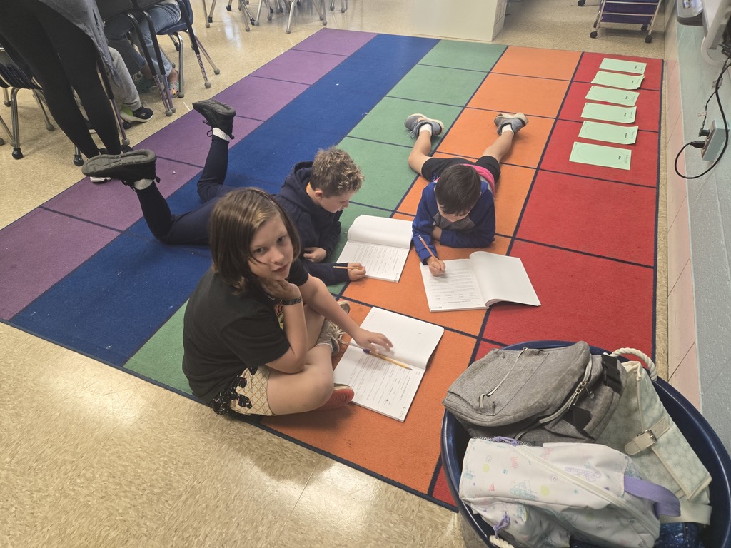 Students working together on an area rug
