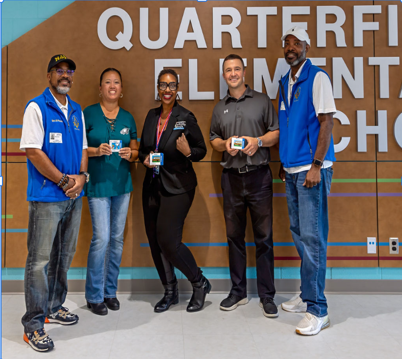 3 staff members posing with 2 Lodge members and donation