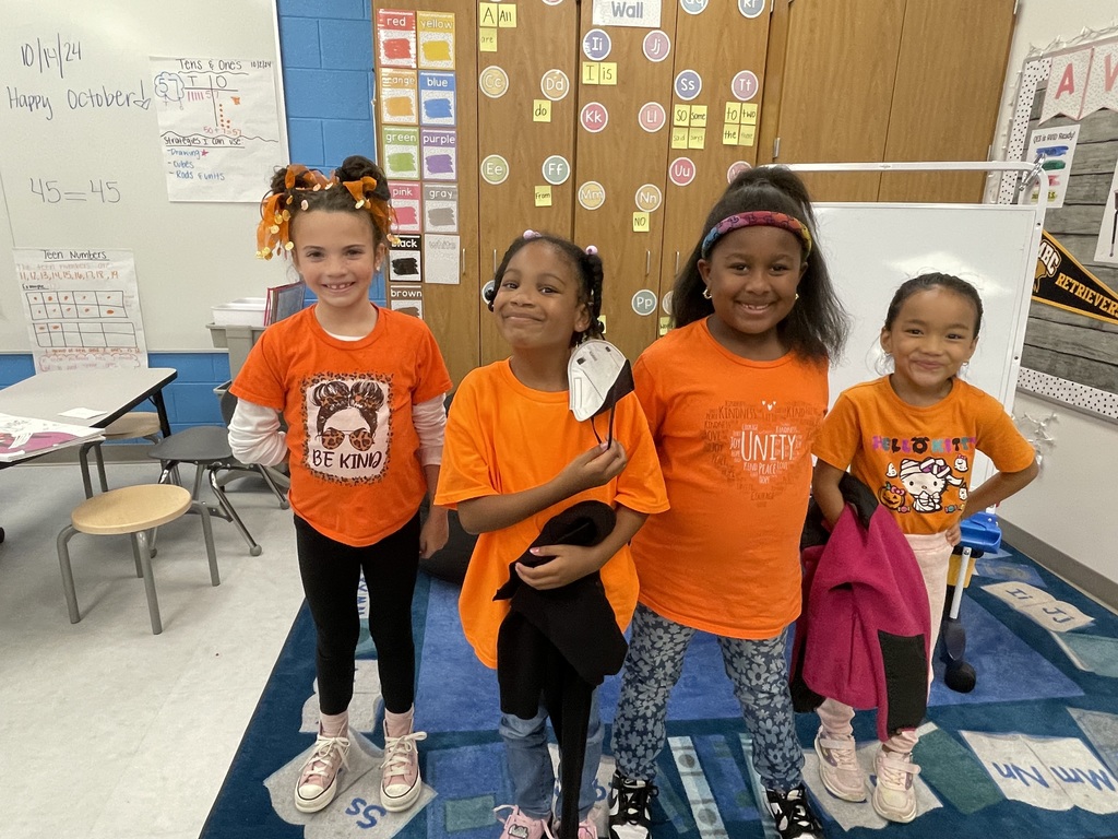 Students on carpet, dressed in orange for UNity Day