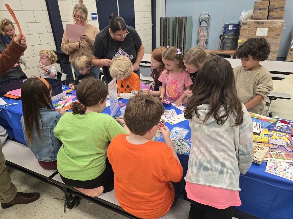 Students at a table making bookmarks