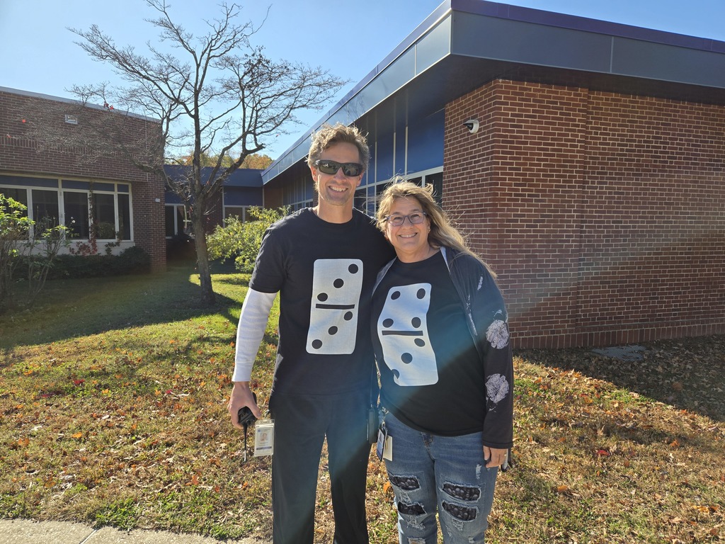Two teachers wearing t-shirts with dominoes.
