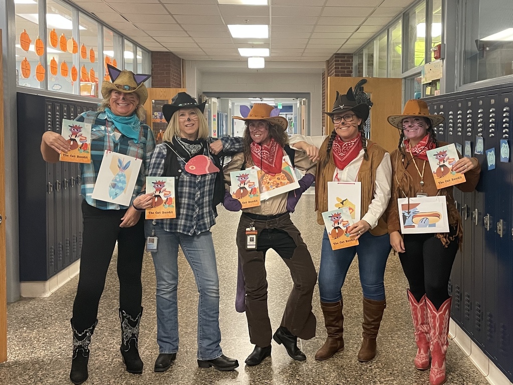 Women standing in the hallway dressed in western gear.