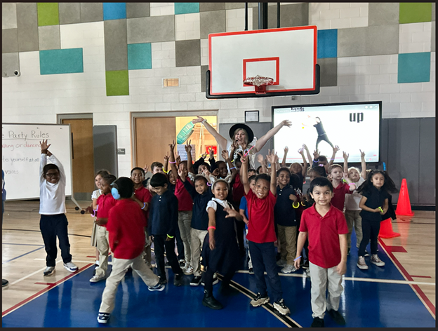 Students posing with Taylor Swiift look alike at dance party.