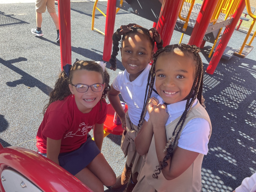 Three second graders at recess playing