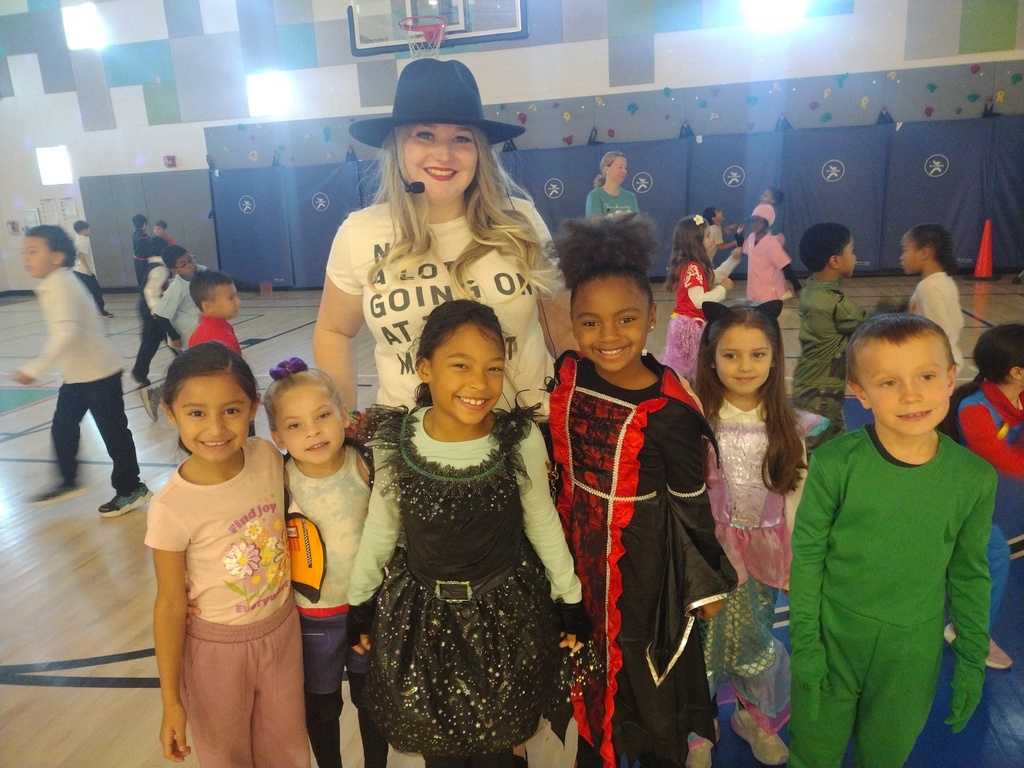 Teacher dressed up like Taylor Swift with students on halloween