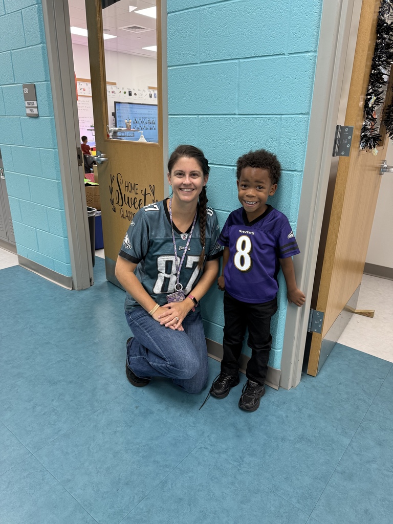 Prek teacher and student in sports jerseys