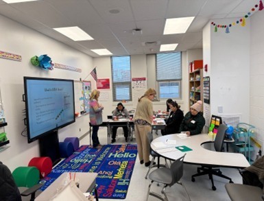 Photo of our ESOL  teacher talking to families