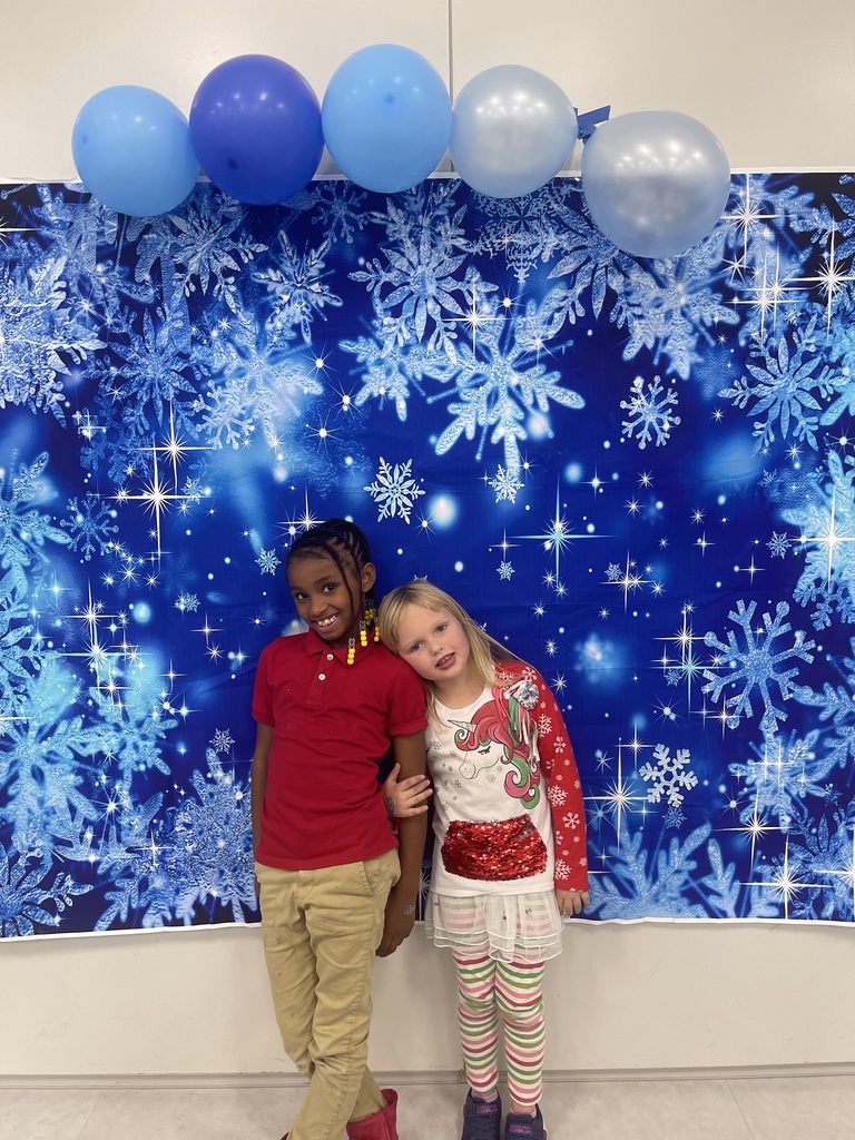 Photo of students in front of winter scene at last years Winter Gala event