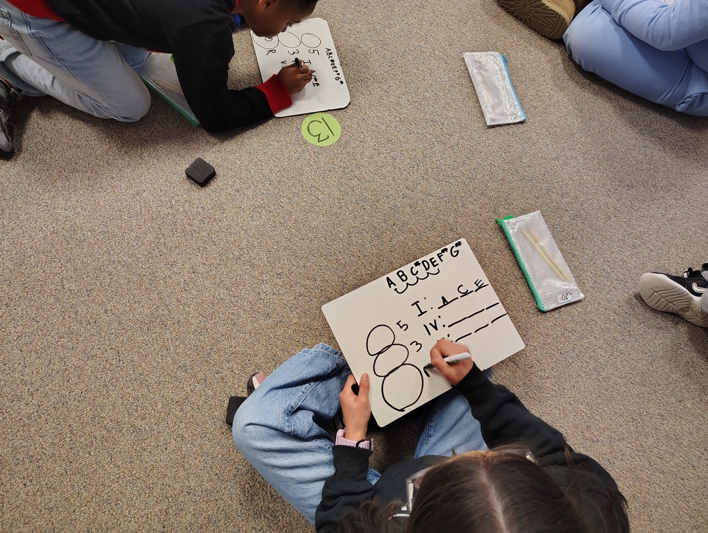 students writing chords on their own whiteboards
