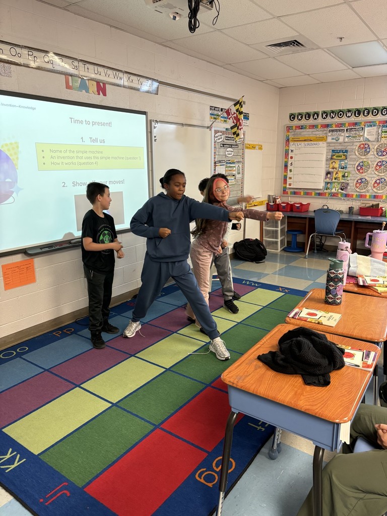 Students showing how simple machines work through dance. 