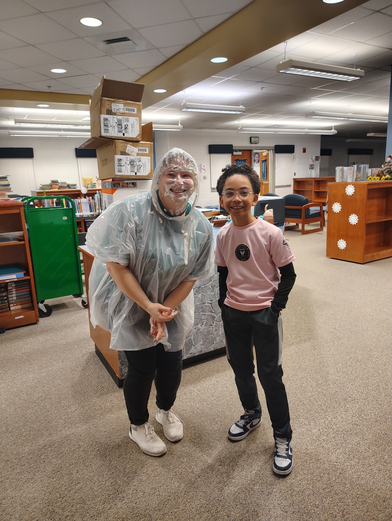 teacher and student. Teacher has whipped cream all over face.