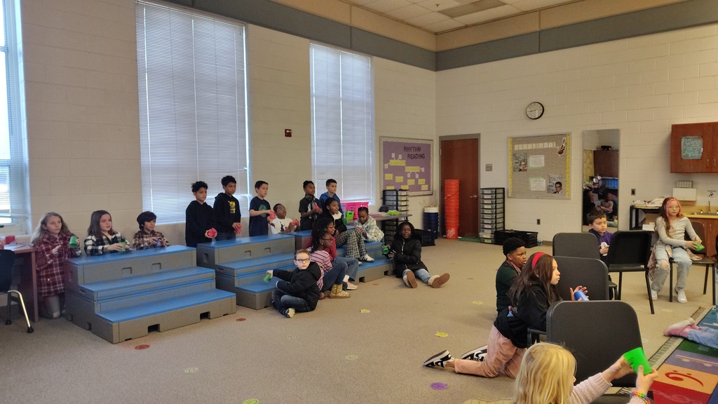 students in a music room with cups