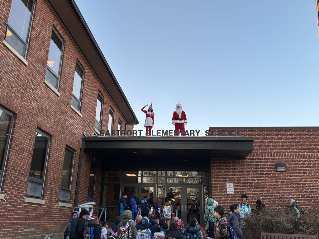 Santa and Elf on the roof of Eastport, students looking.