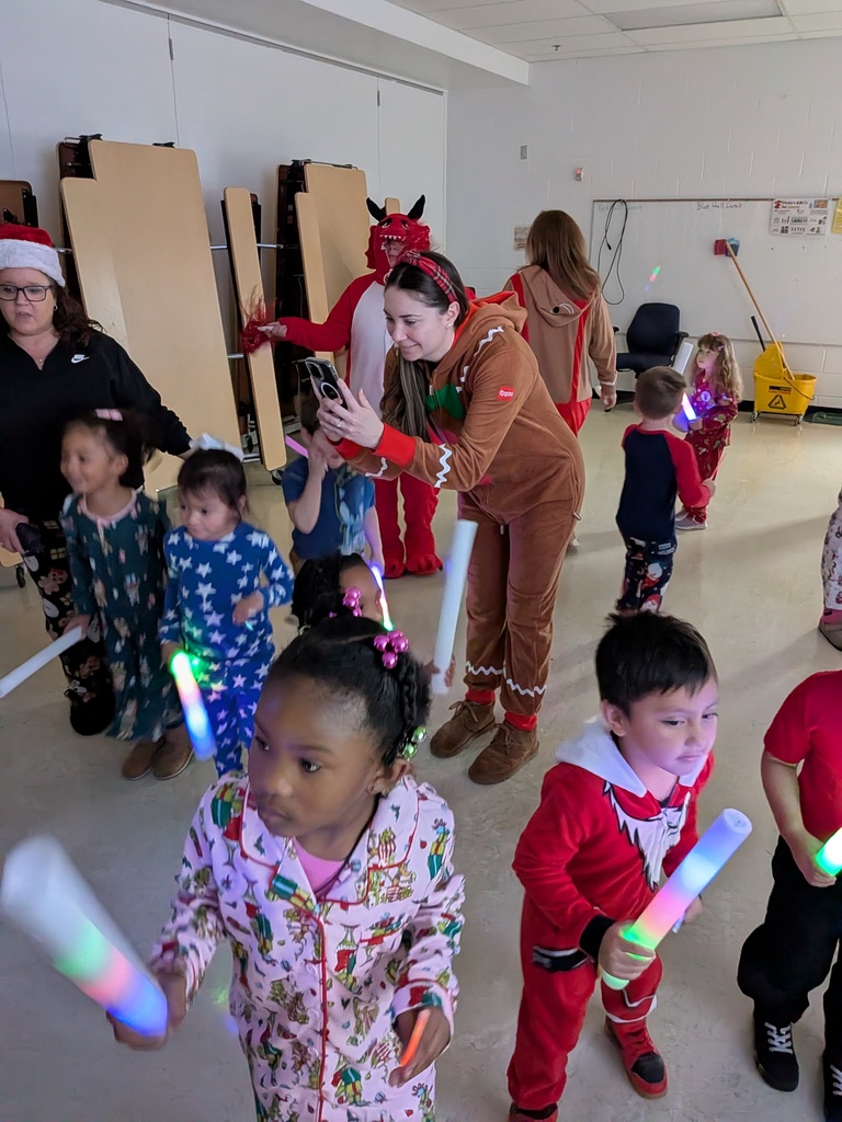 Children dancing with Dinky, the school mascot