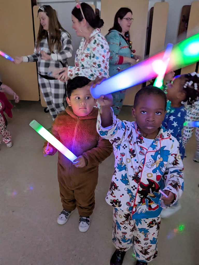 Children dancing with Dinky, the school mascot