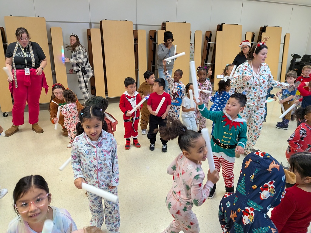 Children dancing with Dinky, the school mascot