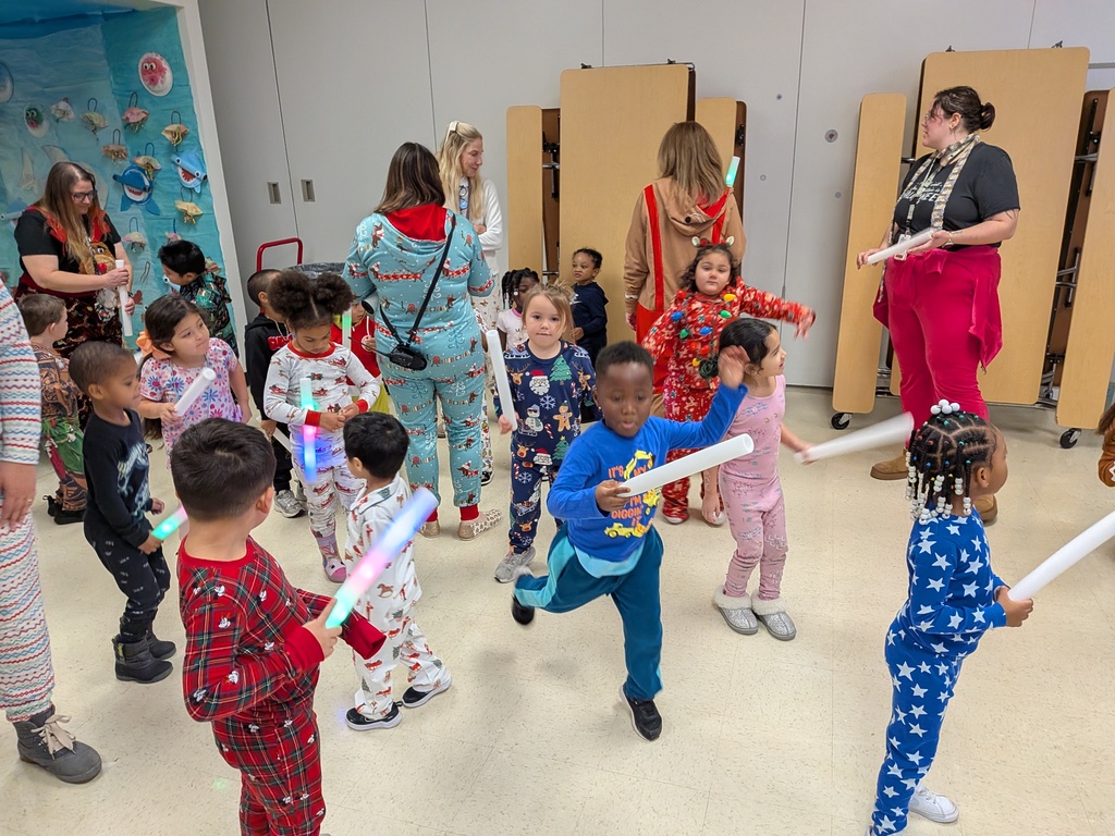 Children dancing with Dinky, the school mascot