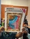 Student holding up their painting. 