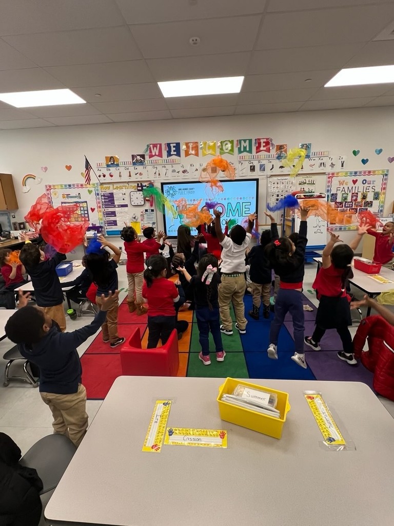 LIbraian throwing scarves with students