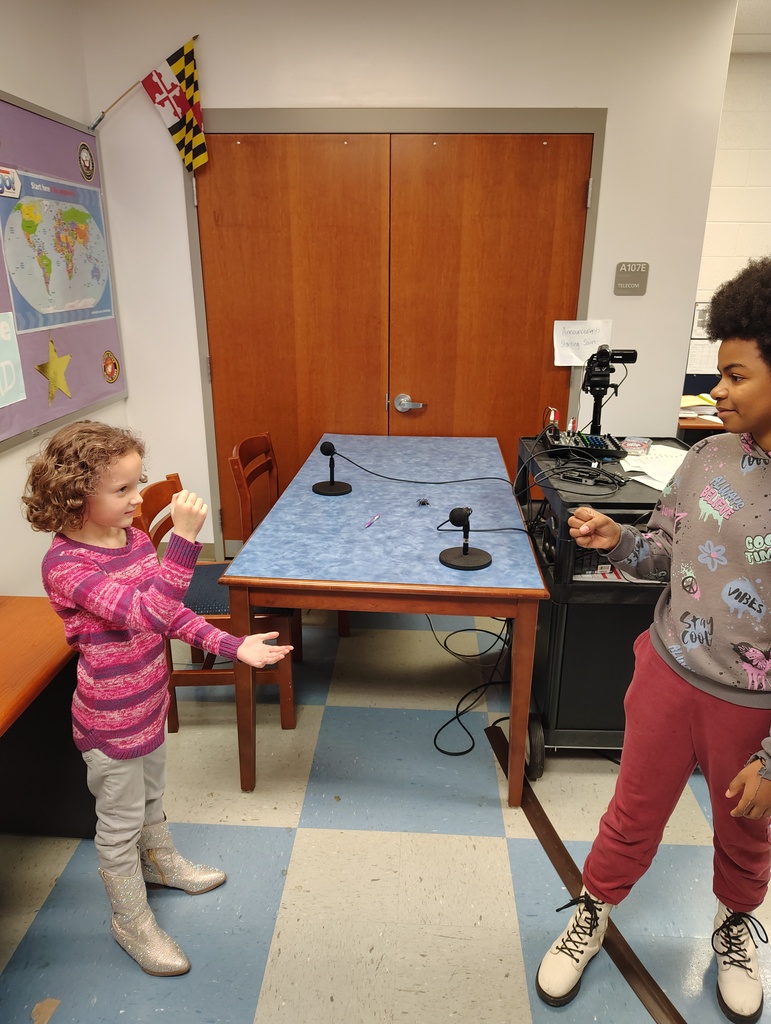 two female students playing rock-paper-scissors