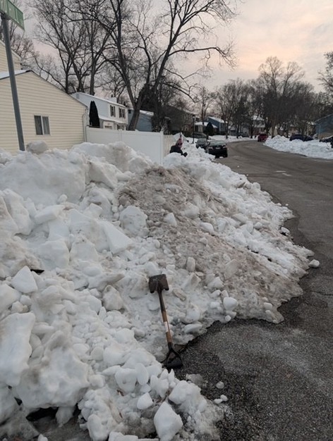 Ms. Brewer deep in a pile of snow 