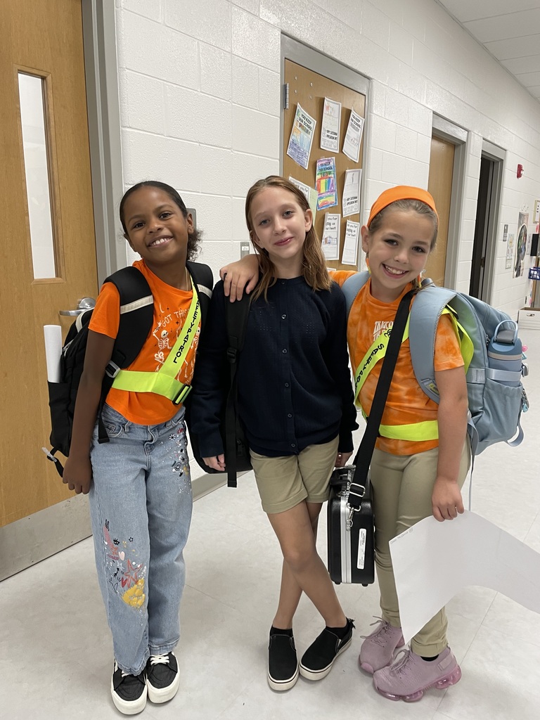 Students in safety club uniforms posing in the hallway
