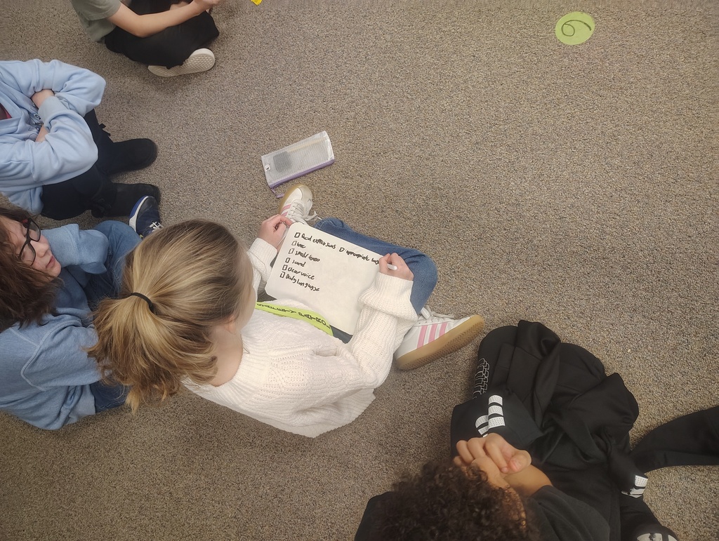 students with whiteboards writing a checklist