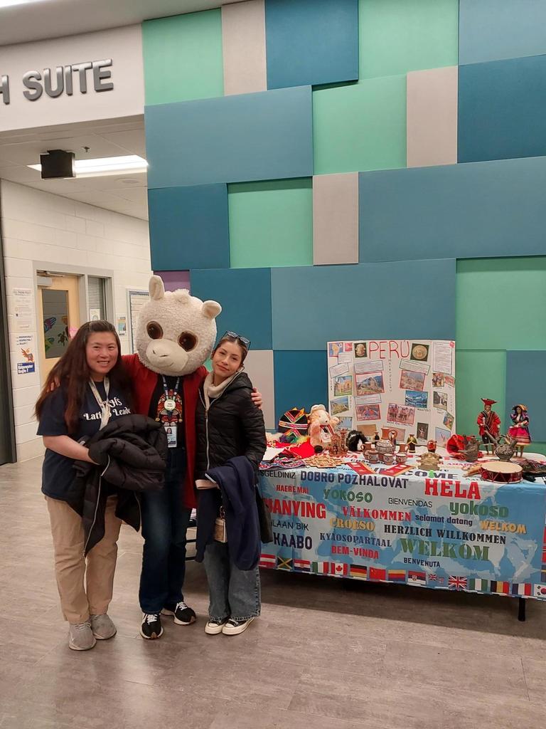 Presentors at  the Edgewater Elementary International Night.  One is wearing a lama costume head.  