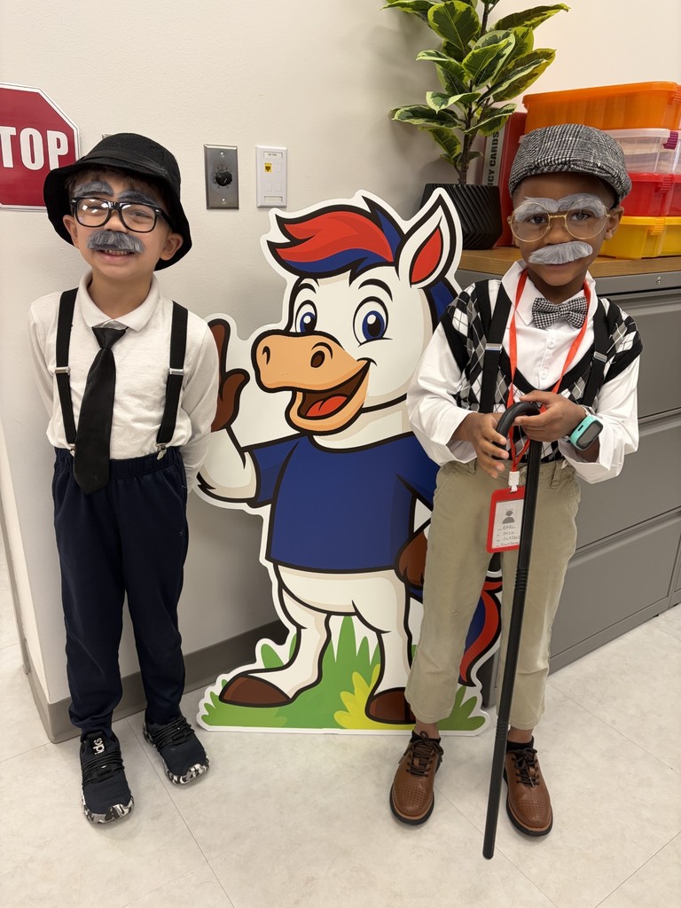 Students dressed up like two old men with gray hair and hats